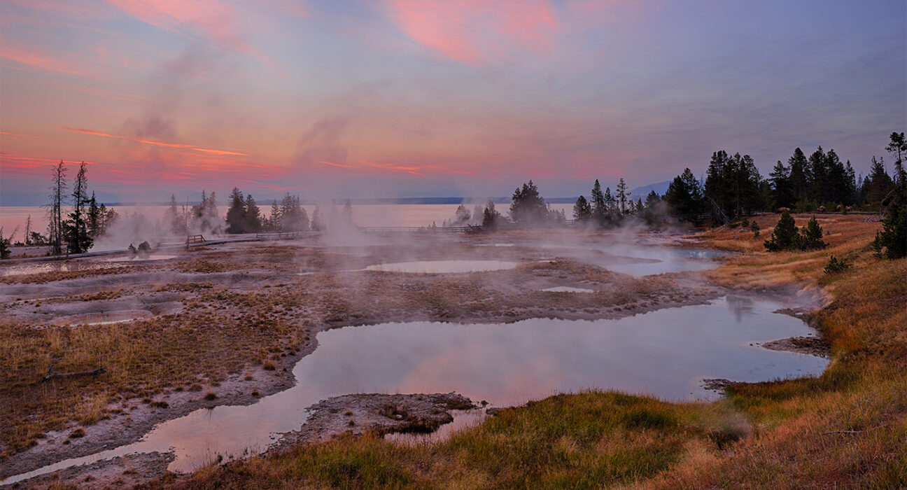 A photograph of the landscape in West Thumb Geyser Basin and Yellowstone Lake (in the photo