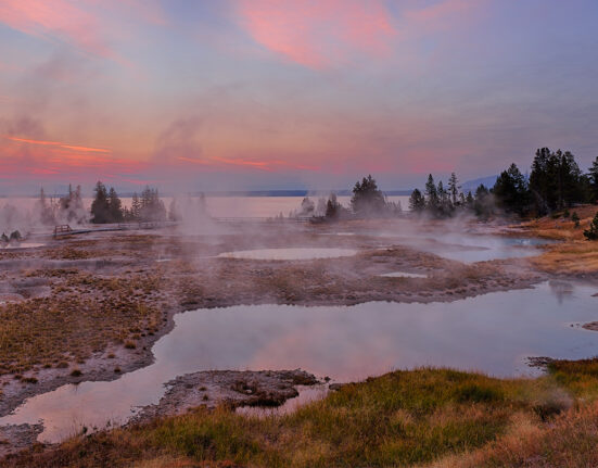 A photograph of the landscape in West Thumb Geyser Basin and Yellowstone Lake (in the photo