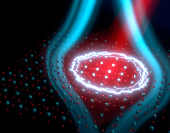 An illustration shows a grid of atoms being hit with a red beam of laser light. Blue lines indicating a magnetic field emanate from the lit-up region.