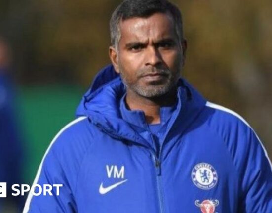 Vinay Menon at Chelsea training wearing a Chelsea jacket