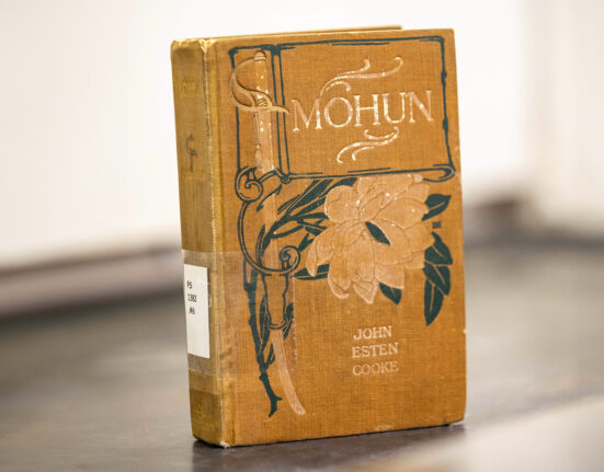 A Victorian-era book titled Mohun is propped up to show it