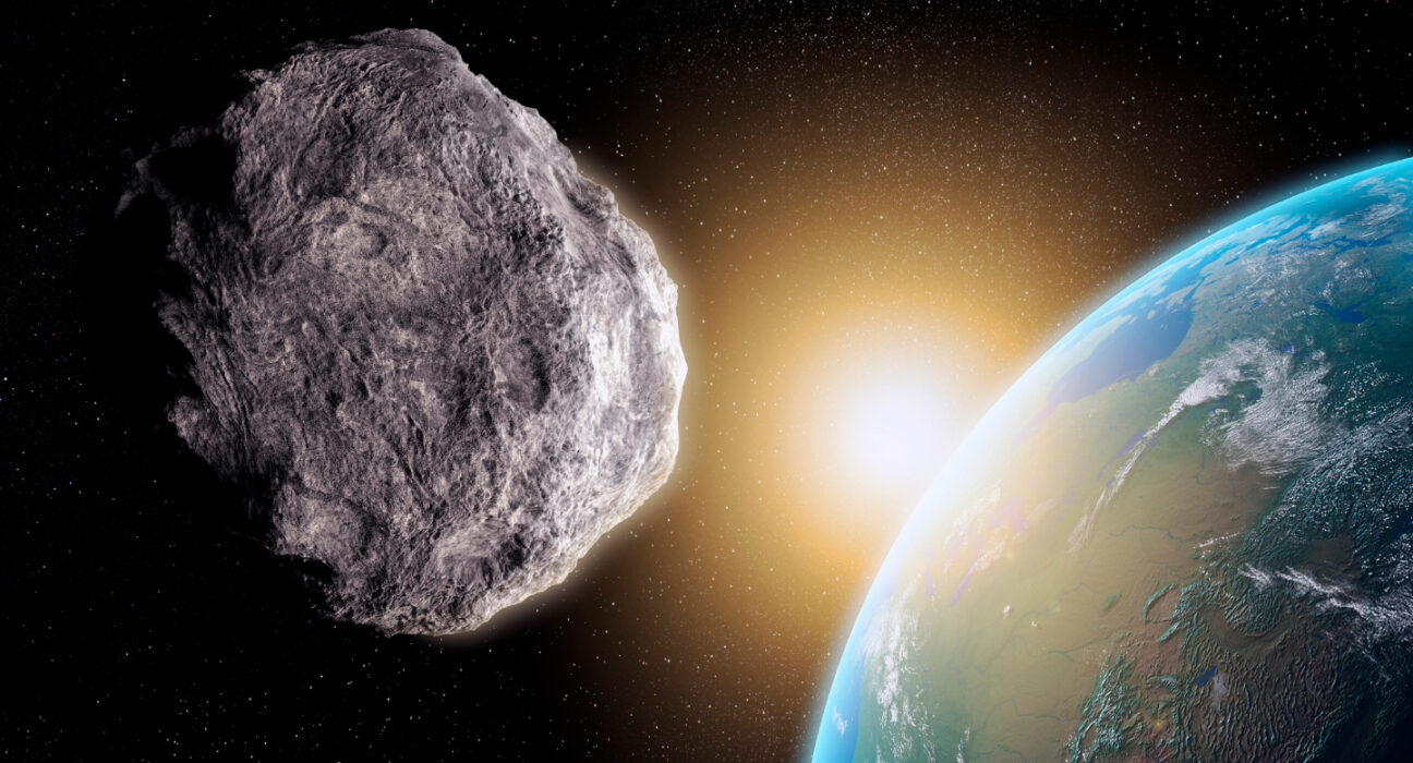 An asteroid floats in space in the foreground, with the Earth in the background.