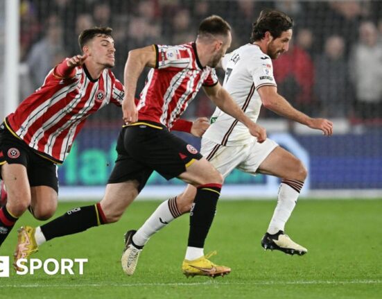 Swansea City midfielder Joe Allen runs with the ball against Sheffield United