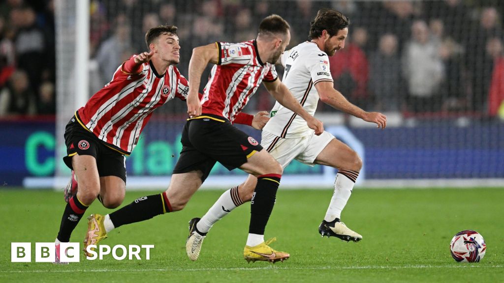 Swansea City midfielder Joe Allen runs with the ball against Sheffield United