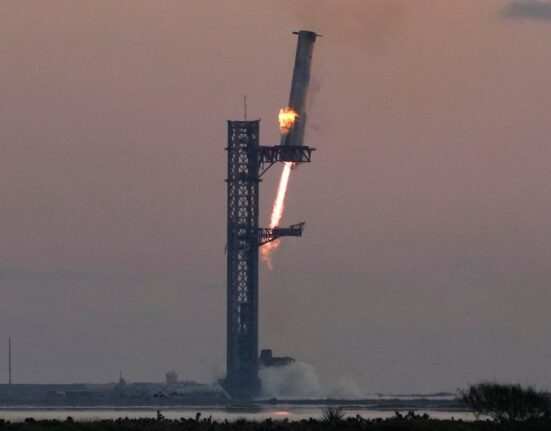 SpaceX catches Starship rocket booster on Texas launch pad