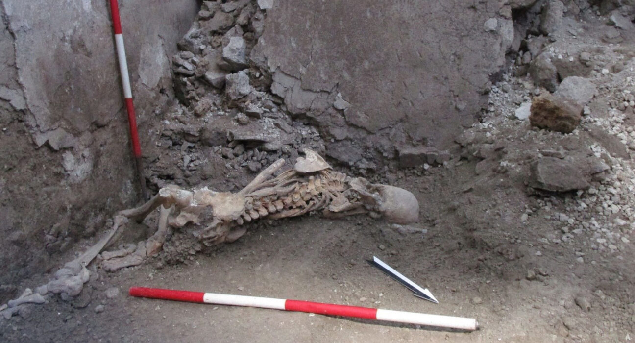 A photo of a skeleton with broken bones in an excavated house in Pompeii, Italy.