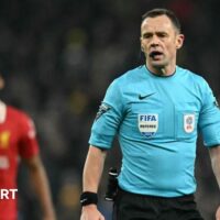 Referee Stuart Attwell is talking during Tottenham's League Cup game against Liverpool