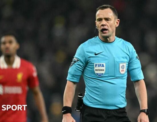 Referee Stuart Attwell is talking during Tottenham's League Cup game against Liverpool