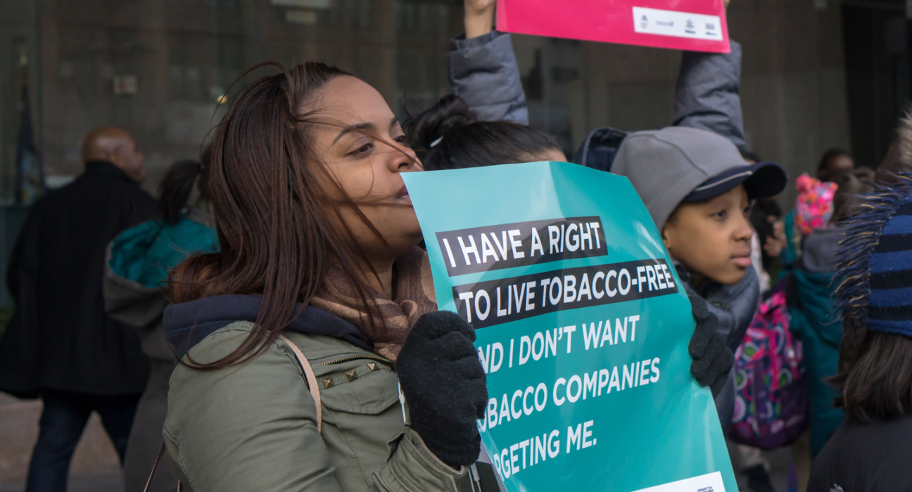 A crowd of young people holding signs, including one saying "I have a right to live tobacco free"